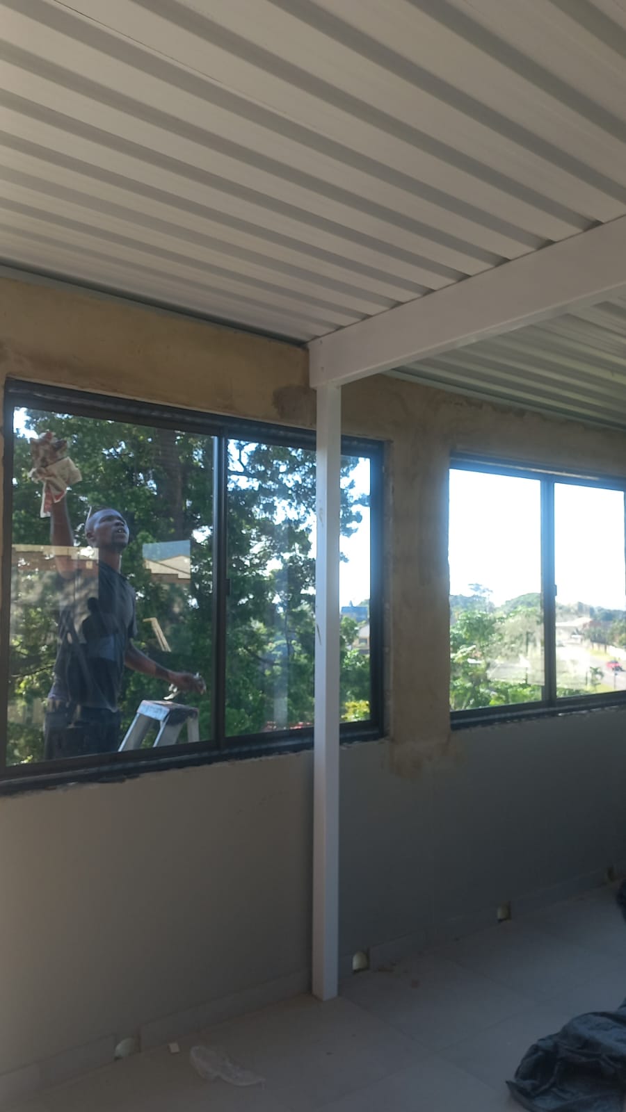 Morgz team cleaning glass on a new window installation