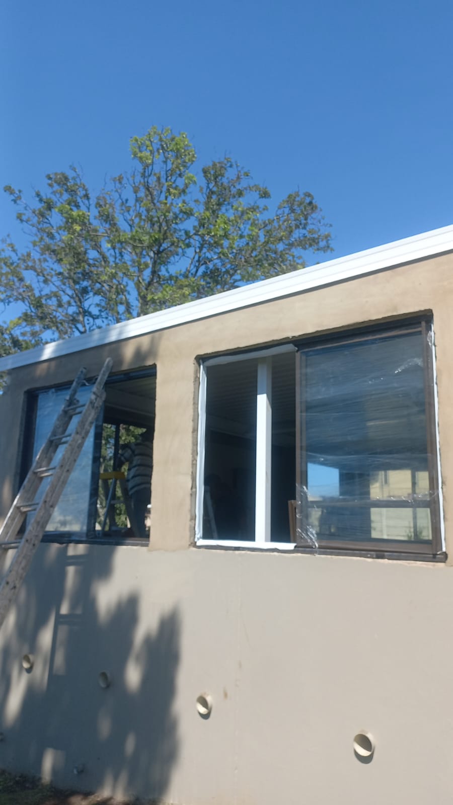 Aluminium windows being installed on a new build exterior