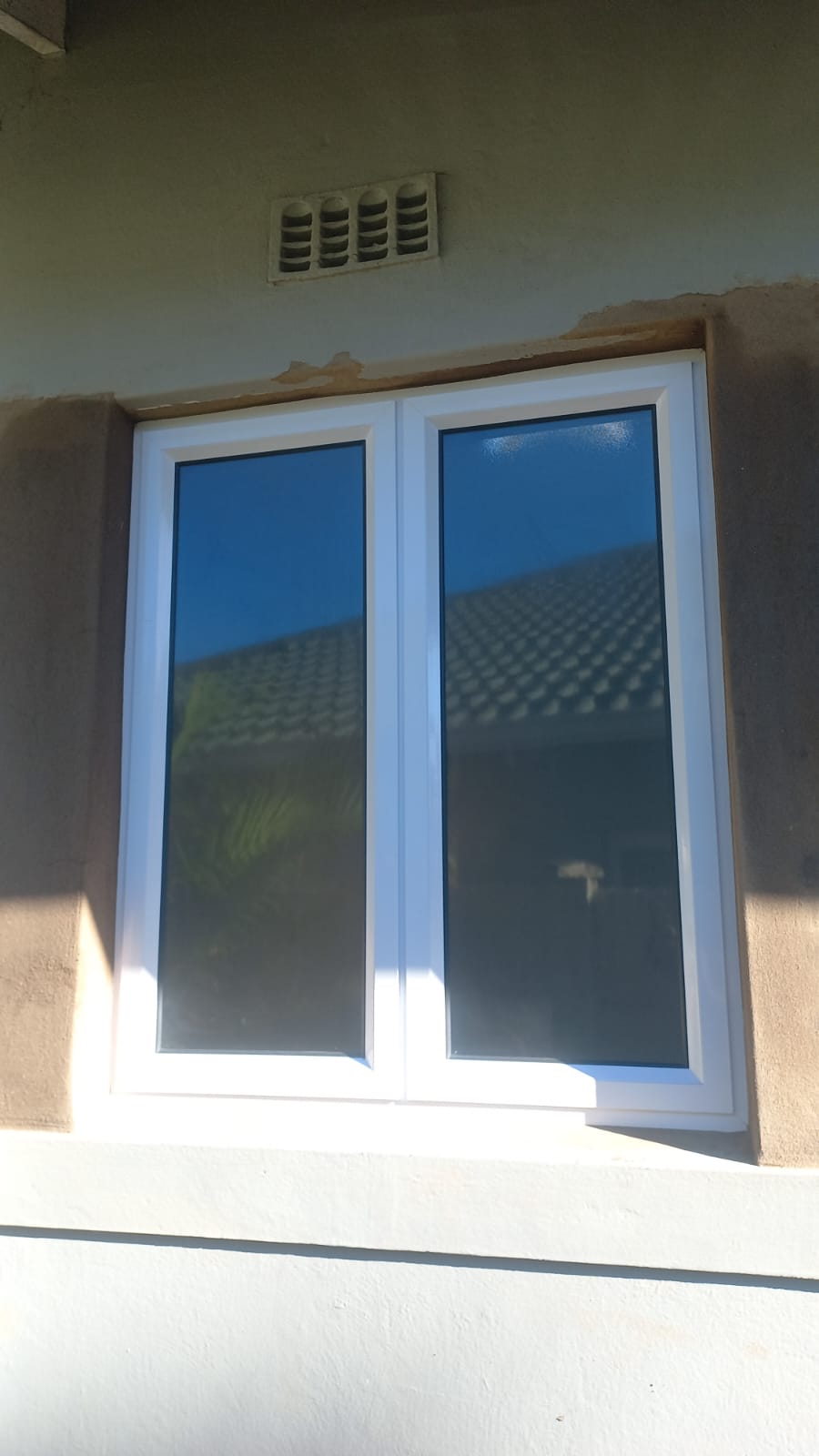 White aluminium double window fitted in an exterior wall