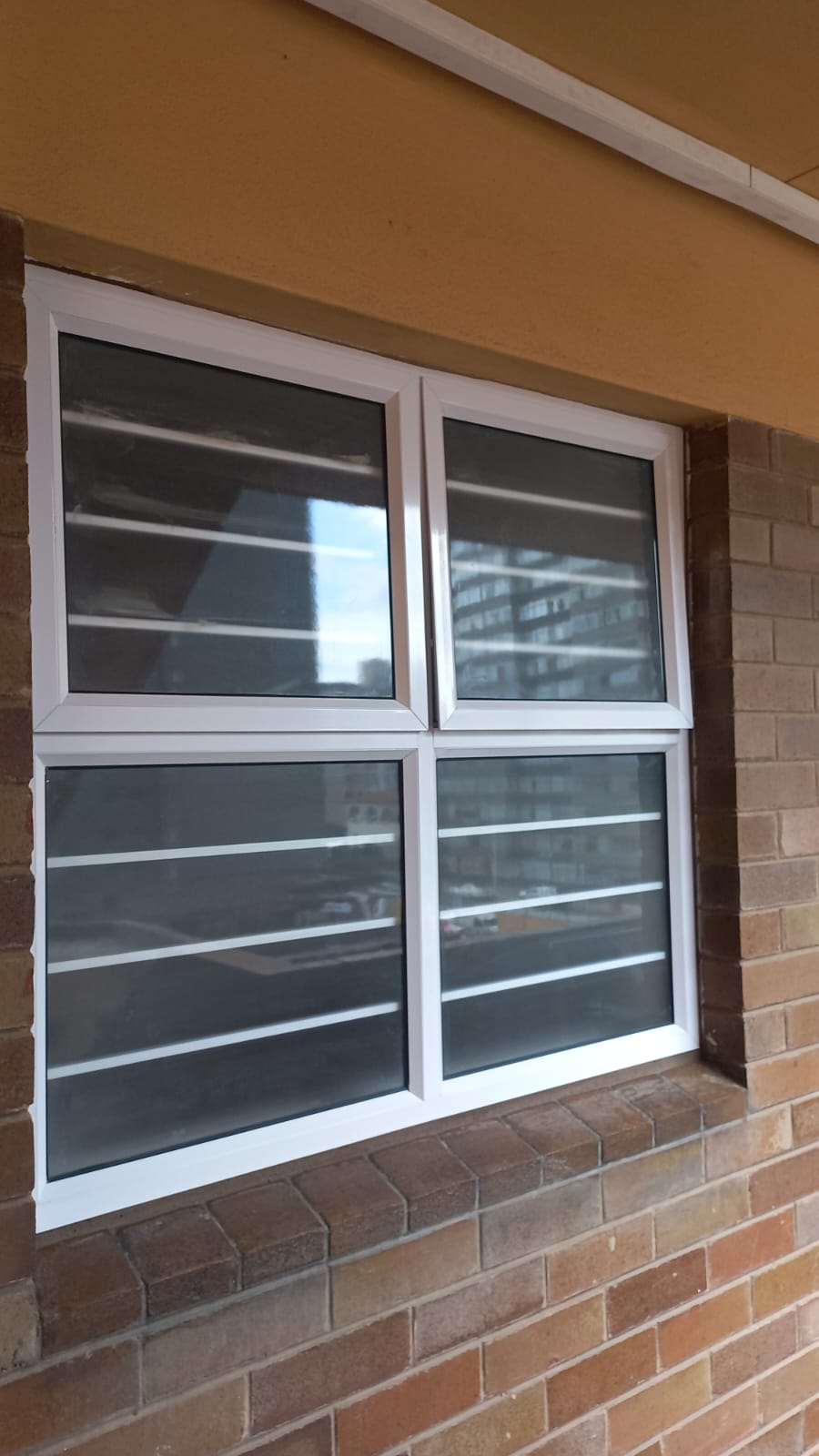 White aluminium double window installed in brick wall