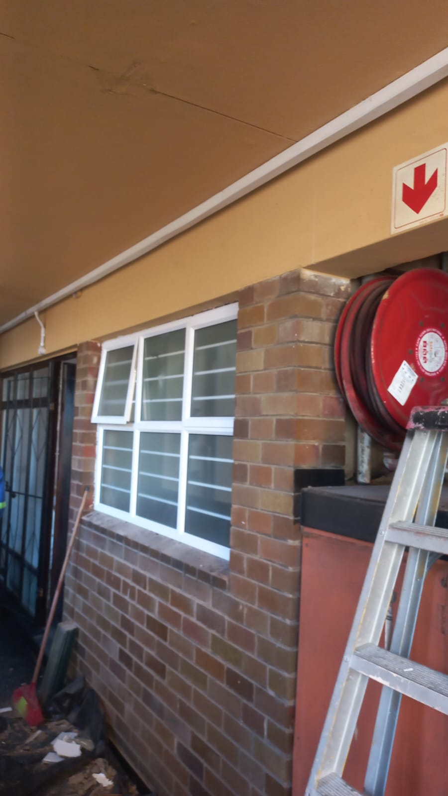 White aluminium office window with security bars