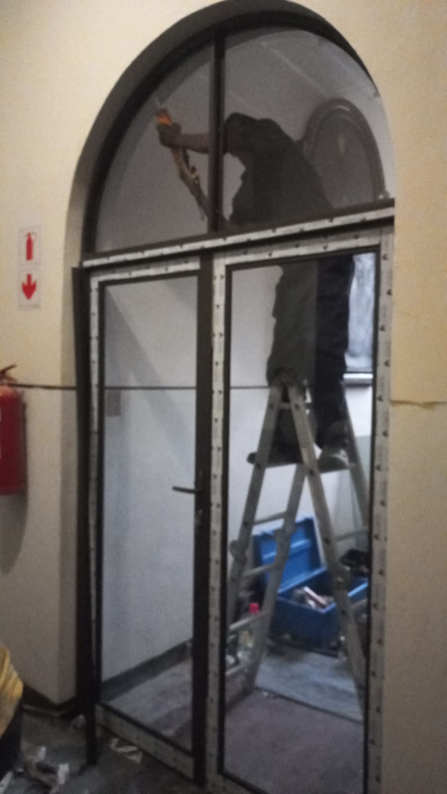 Arched aluminium and glass door installation