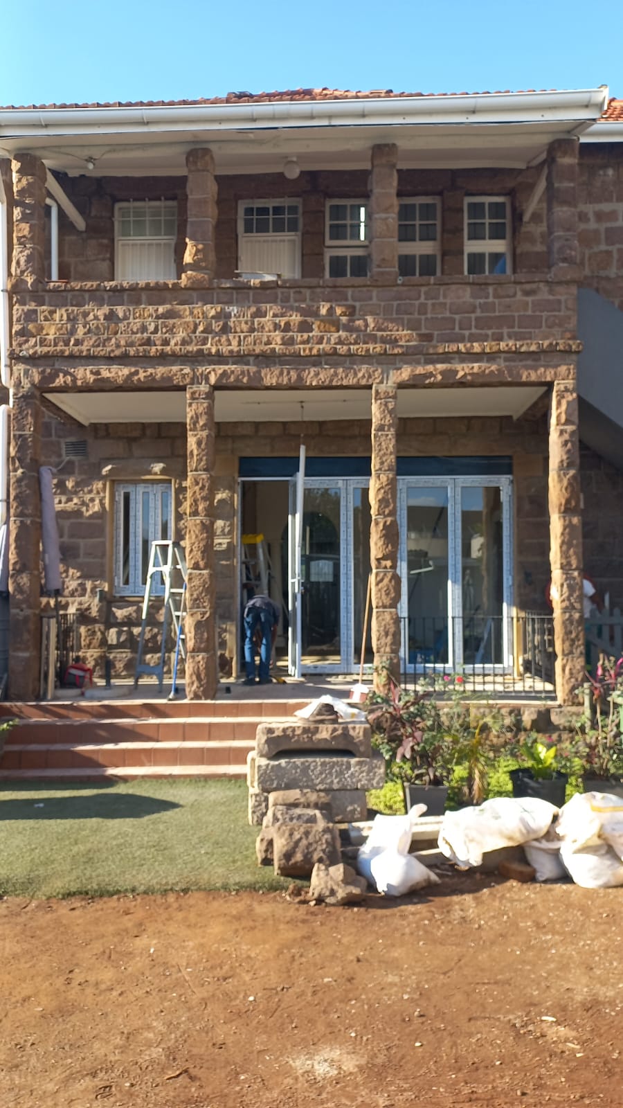 Aluminium sliding door installation on a stone home