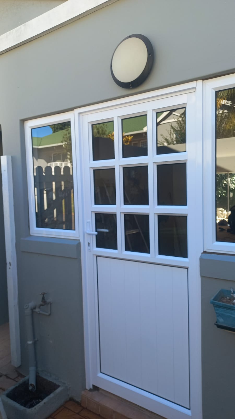 White aluminium door with glass panels installed at a home