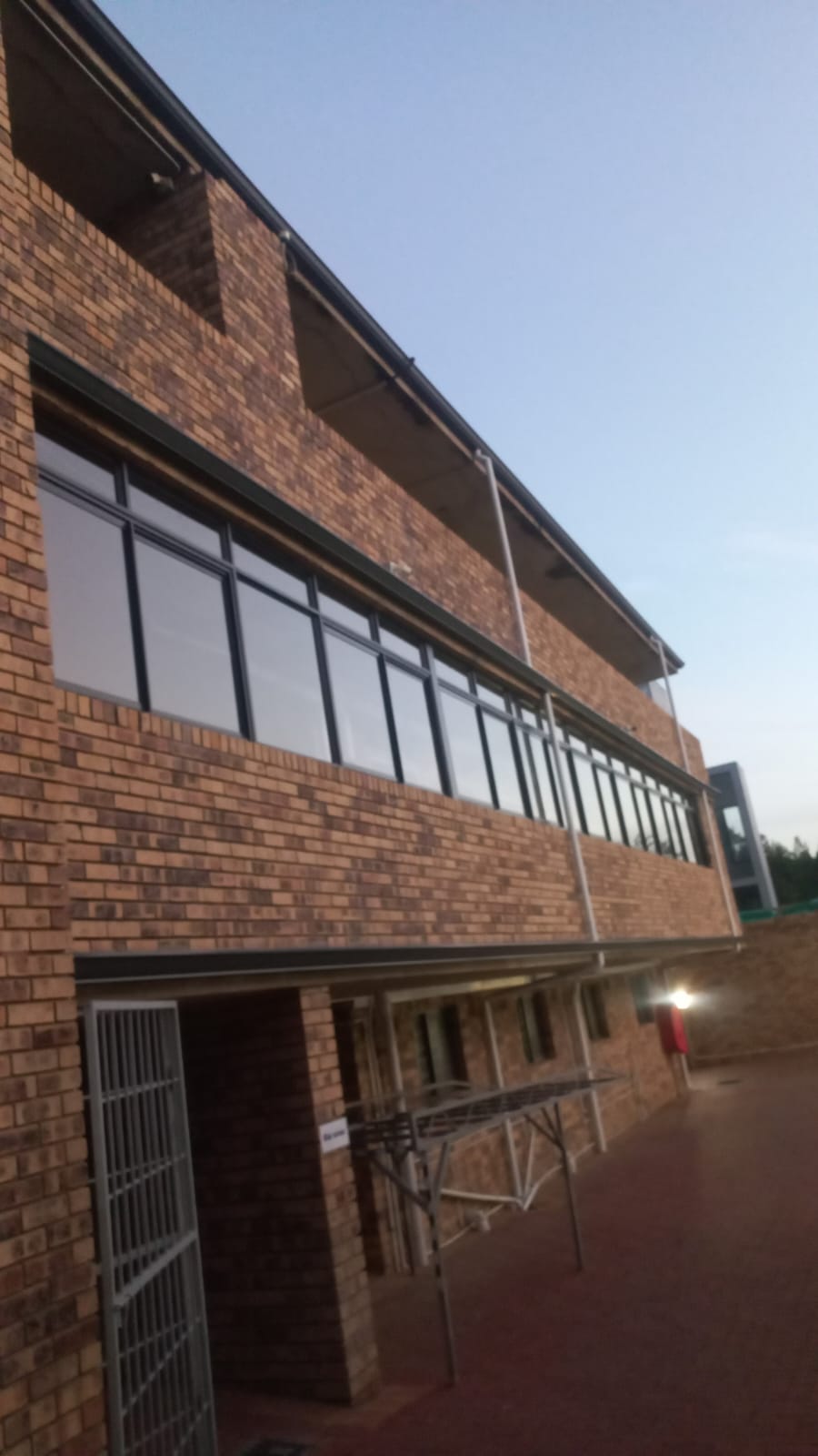 Aluminium windows on a brick building at dusk